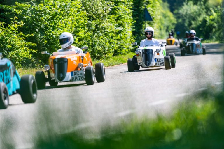 Mehrere Personen in bunten Hotrods bei der Hotrod Tour Mergellandroute in Aachen